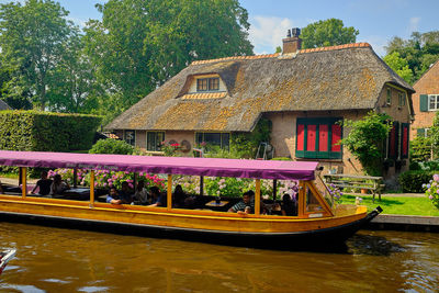 House by canal against building