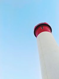 Low angle view of lighthouse against clear blue sky