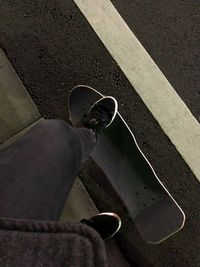 Low section of man standing on road