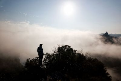 Man standing on mountain against sky