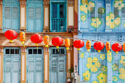 Low angle view of chinese lanterns hanging against building