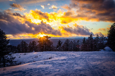 Scenic view of snow covered landscape against cloudy sky