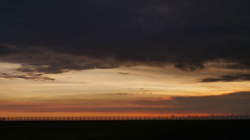 Scenic view of dramatic sky over sea during sunset