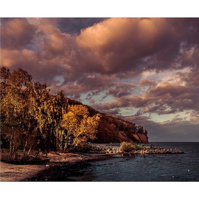 sky, water, cloud - sky, tranquil scene, sea, scenics, tranquility, cloudy, beauty in nature, transfer print, nature, cloud, horizon over water, auto post production filter, overcast, weather, idyllic, tree, outdoors, beach