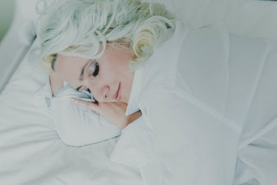 High angle view of woman sleeping on bed