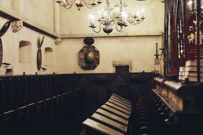 Empty chairs against wall in restaurant