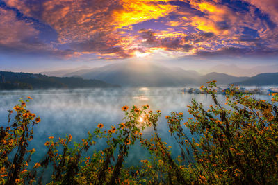 Scenic view of lake against sky during sunset