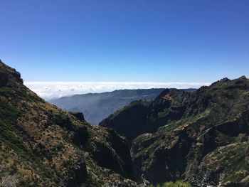 Scenic view of mountains against clear blue sky