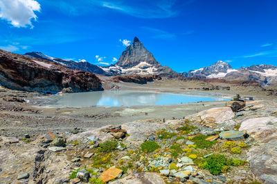 Scenic view of landscape against blue sky