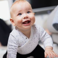 Portrait of cute baby boy sitting on table