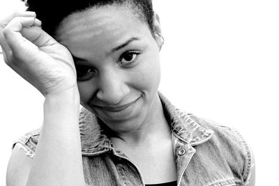 Portrait of young woman against white background