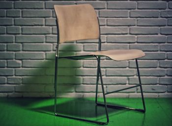 Close-up of chair against wall
