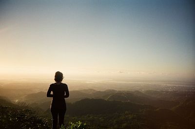 Silhouette of woman standing on landscape