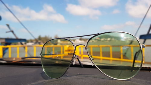 Sunglasses on road against sky