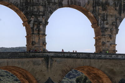 Low angle view of arch bridge against sky