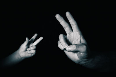 Close-up of human hand against black background