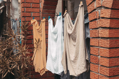 Clothes drying against brick wall