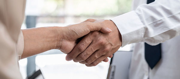 Close-up of business people shaking hands