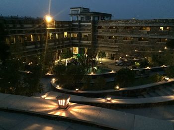 High angle view of illuminated buildings by street at night