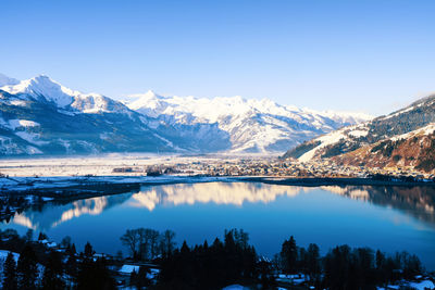 Scenic view of lake and mountains against sky during winter