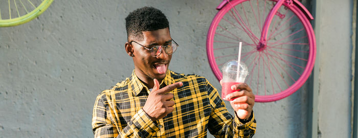 Low angle view of man holding bicycle