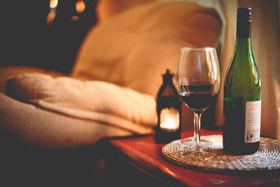 Close-up of hand holding beer glass on table