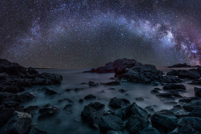 Scenic view of sea against star field