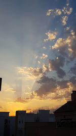 Low angle view of silhouette buildings against sky during sunset