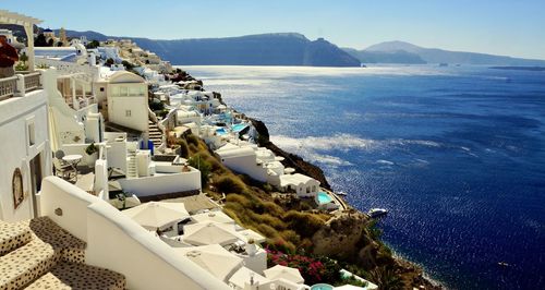 High angle view of buildings by sea against sky