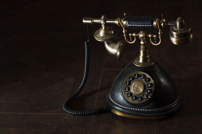 Close-up of old-fashioned telephone on table