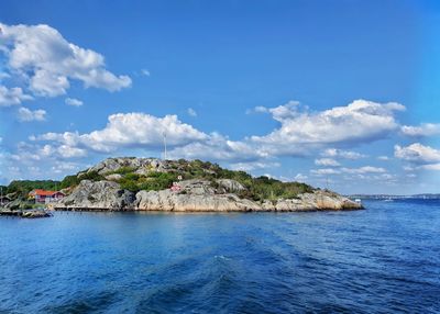 Scenic view of sea by buildings against sky