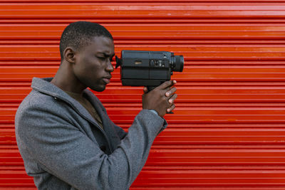 Portrait of young man photographing