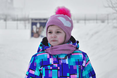 A girl dressed in the street in winter. portrait. side view.