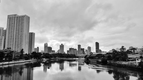 Reflection of buildings in city against sky