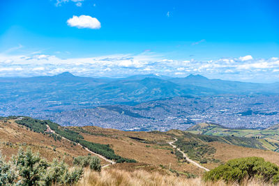 Scenic view of mountains against blue sky