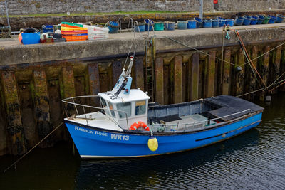 Fishing boats moored at harbor