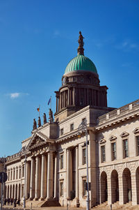 Low angle view of historical building against blue sky