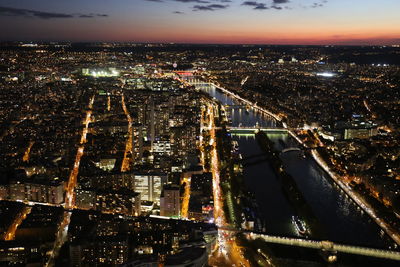 High angle view of illuminated city against sky at night