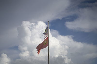 Low angle view of flag on pole against sky