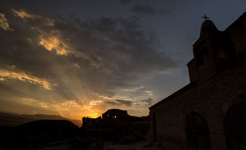 Low angle view of silhouette church against sky during sunset