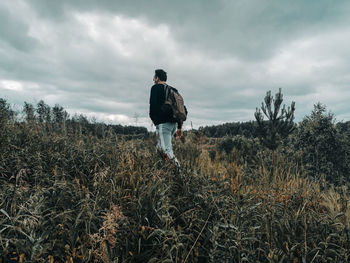 Man standing on field against sky