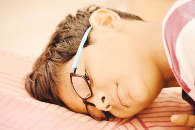 Close-up of boy lying on bed