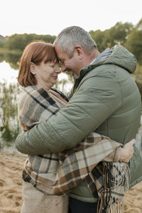 Couple wearing warm clothing embracing each other