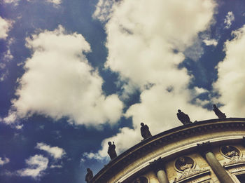 Low angle view of building against cloudy sky