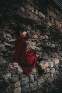 Woman on red wall