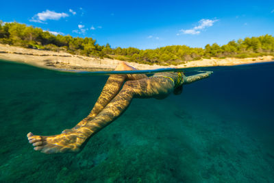 Girl diving in the adriatic sea on hvar island, croatia