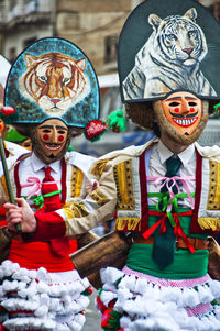 Men wearing costumes marching in city