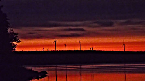 Silhouette of landscape against cloudy sky