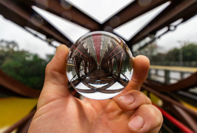 Close-up of hand holding crystal ball