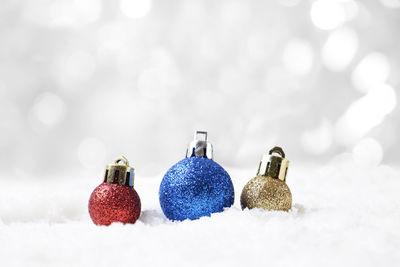 Close-up of baubles on snow